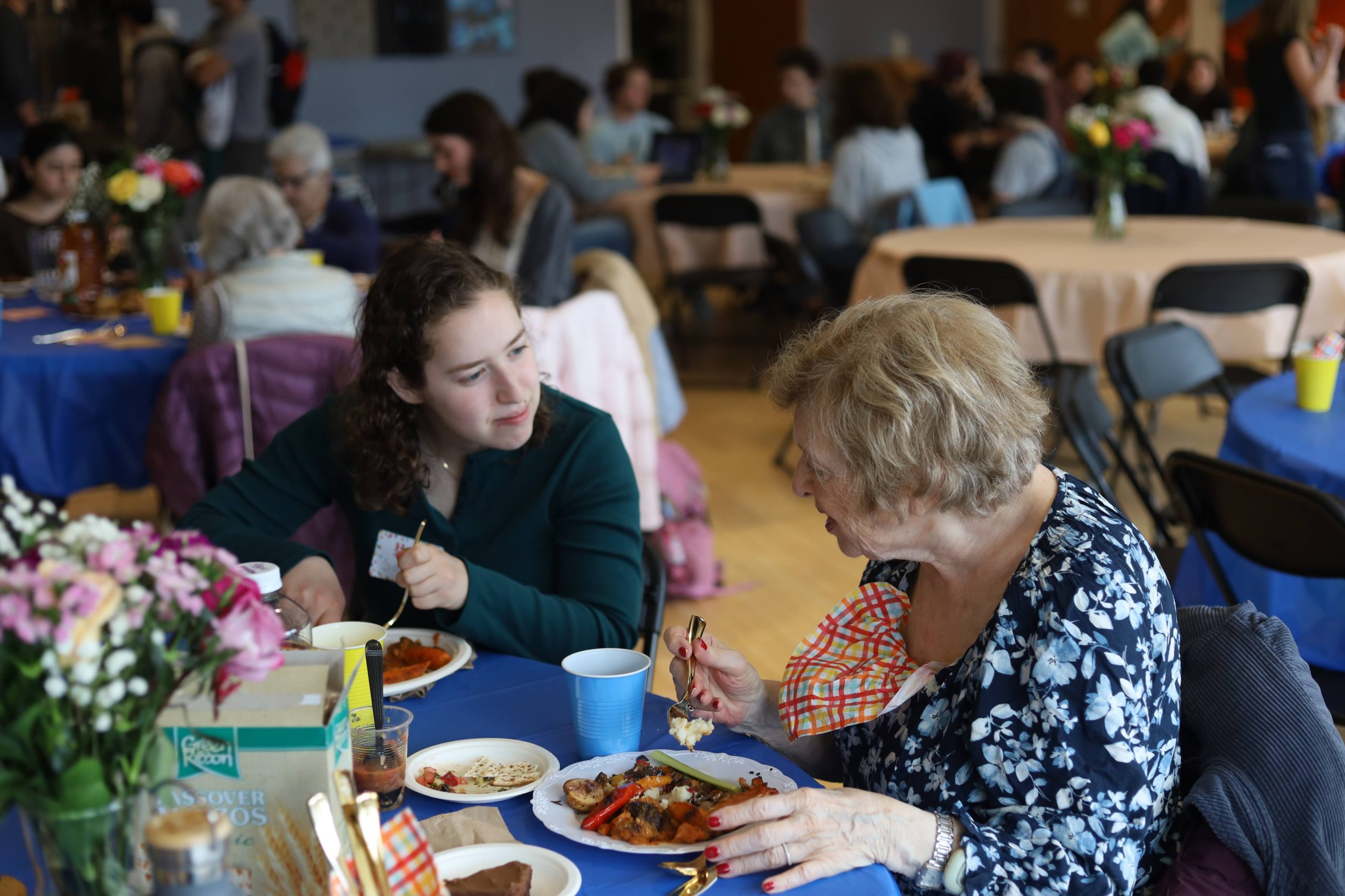 Tufts student and Cabot Park Village resident sharing a meal together